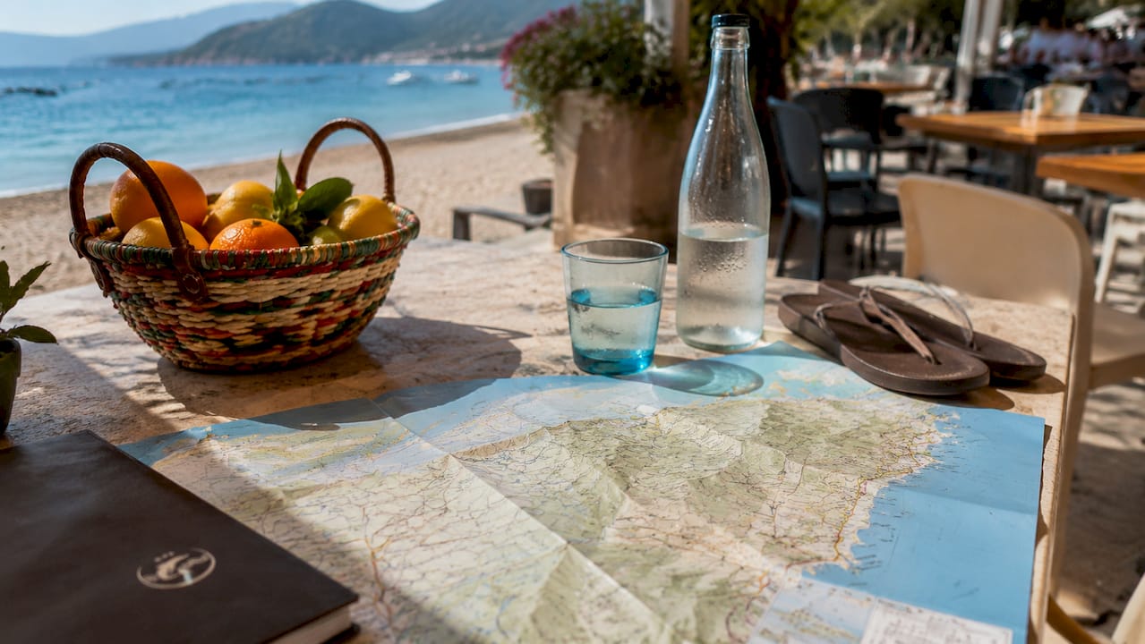 Dettaglio di una mappa dei sentieri dell’Elba, circondata da accessori da viaggio